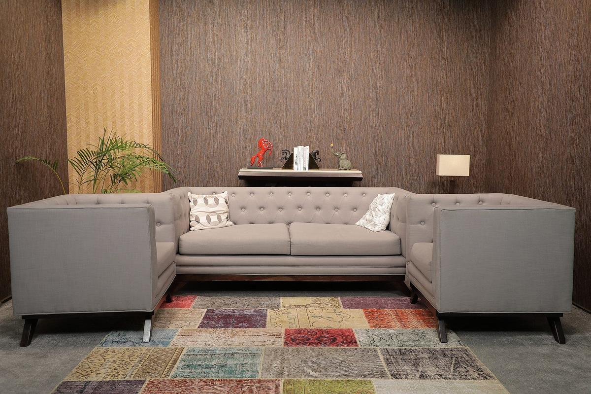 Content Studio lounge sofa set — grey sofa, patterned carpet, warm lighting, Gurugram podcast studio