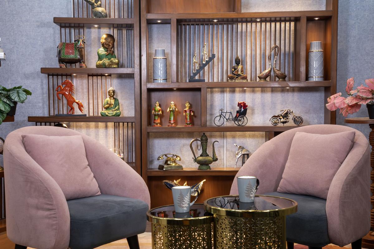 Content Studio main camera mid-frame — two podcast chairs facing each other, professional three-camera setup, Gurugram podcast studio