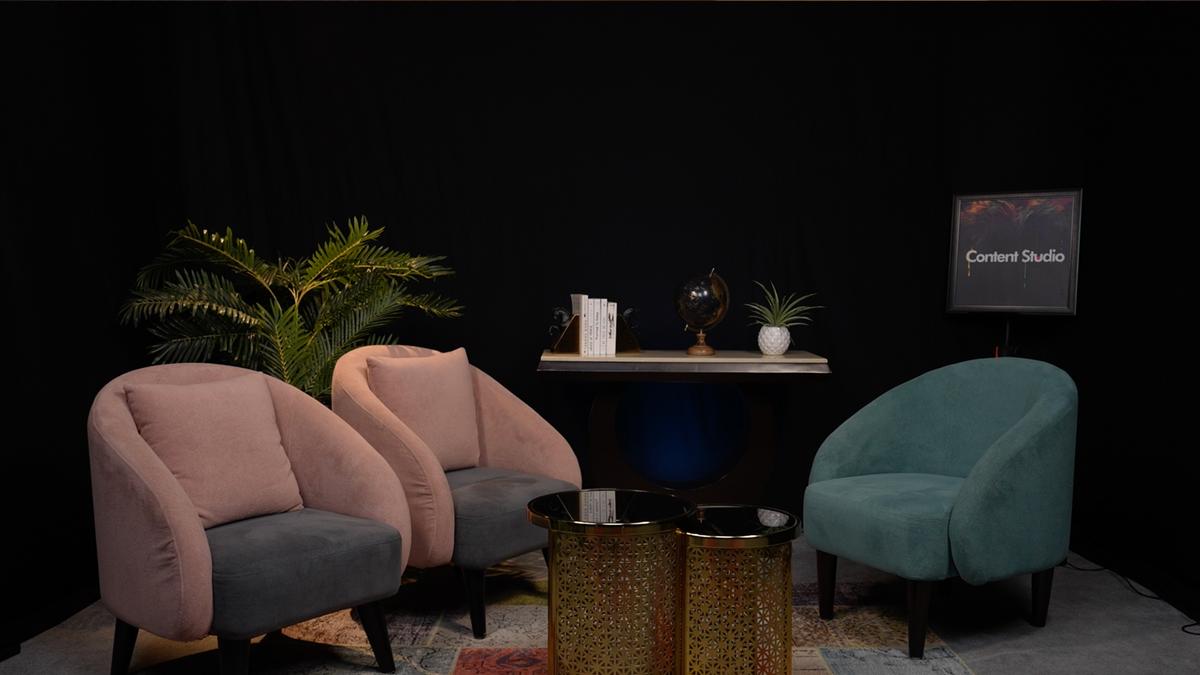 Content Studio interview set — host seated with plants and curated props, professional podcast setup, Gurugram