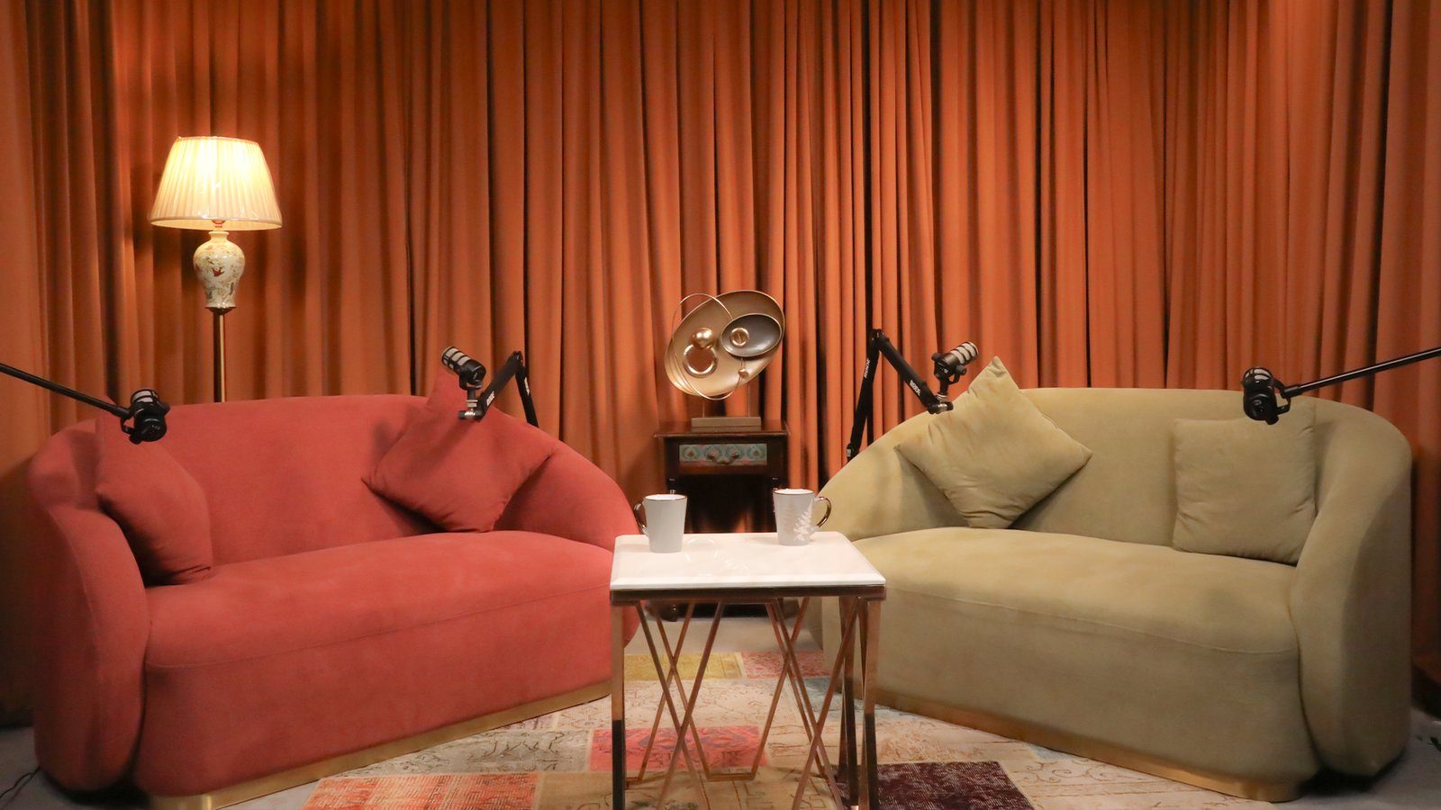 Content Studio modern set — pink velvet chairs, brass tables, contemporary backdrop, Gurugram video production